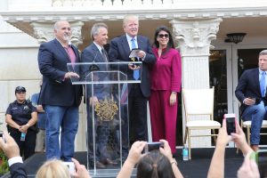 Council members Pete Cabrera and Christy Fraga and Ana Maria Rodriuez flank Mayor Luigi Boria and Donald Trump in March.