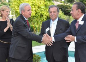 Carlos Gimenez shakes Mitch Maidique's hand at a fundraiser at Jeff Berkowtiz's home.